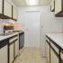 Kitchen with beige and brown countertops at Gladstone Towers apartments for rent in Lansdowne, PA