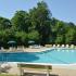 Swimming pool with lounge chairs at Rolling Glen Townhomes and Apartments in Boothwyn, PA.