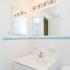 White bathroom with tile and sink with vanity
