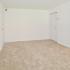 Living room with beige carpets and closet doors at Boothwyn Court apartments for rent