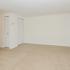 Dining room with beige carpet and closet storage space at Boothwyn Court apartments for rent