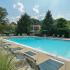 Outdoor swimming pool with lounge chairs and umbrellas at Fairway Park apartments for rent