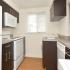 Galley kitchen with hardwood floors and white appliances in Wilmington, DE apartment for rent