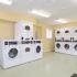 Community laundry center with numerous washers and dryers for resident use