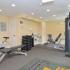 Free weights and strength training equipment in apartment fitness center
