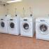 Community laundry center with washers and dryers at Gayley Park apartments in Media, PA