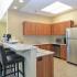 Community center kitchen with bar seating at The Lafayette at Valley Forge apartments in King of Prussia, PA.