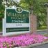 Welcome sign landscaped with flowers at the entrance of Willow Run Apartments in Willow Grove, PA.