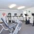 Fitness center with leg curl and leg extension machine at Cedar Tree Village apartments for rent