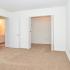 Bedroom with walk-in closet at Cedar Tree Village apartments for rent
