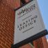Leasing office sign attached to the exterior of the brick building at Waterloo Place Apartments in Baltimore, MD.