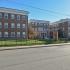 Three 3-Story brick complex buildings at Suburban Court Apartments in Ardmore, PA.