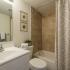 Bathroom with tiled shower and white tub in apartment for rent in Montgomery County, PA