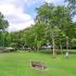 Beautifully landscaped grounds with benches and picnic areas at Park Court Apartments in Reading, PA.