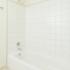 White tiled shower and tub in Newark, DE apartment bathroom