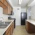 Kitchen with tile floors and modern appliances at Victoria Crossing Apartments in Reading, PA.