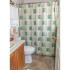 Model bathroom with tiled floors, vanity sink and tub shower at Upper Deerfield apartments in Bridgeton, NJ.