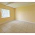 Bedroom with yellow walls and tile flooring in apartment for rent in Westchester Miami, FL