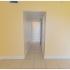 Yellow walls leading in to hallway in Miami, FL apartment for rent