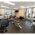 Cardio equipment and free weights in fitness center in Phoenixville, PA apartment complex