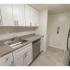 Kitchen with granite countertops and white cabinets at Fox Run apartments for rent