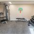 Strength training equipment and free weights in apartment fitness center