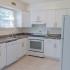 Kitchen with grey cabinets and white countertops at Carlisle Park apartments for rent