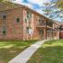 Landscaped exterior of the 2-story brick apartment buildings at Woodland Plaza Apartments in Wyomissing, PA.