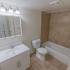 Bathroom with a bathtub, cabinet, and toilet at Caln East apartments for rent