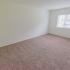 Bedroom with beige carpet and a window at Caln East apartments for rent