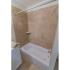 Tiled shower with white tub in apartment for rent in West Chester, PA