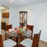 Dining room with track lighting and furnished with elegant table and chairs