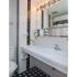 Black and white master bathroom with large mirror and white sink