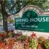 Sign at the entrance that says Spring House Apartments with the phone number 301-490-8833.