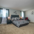 Large master bedroom with two windows and carpet flooring in Woodbury, NJ townhome for rent