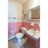 Bathroom with pink tiled walls and a white sink at Evergreen Club apartments for rent in Broomall, PA