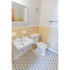 Full bathroom with a vintage black and white tile flooring at Evergreen Club apartments for rent