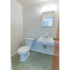 Half bathroom with tile flooring and a white sink with a medicine cabinet at Evergreen Club apartments for rent