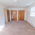 Large bedroom with two closets and a small window at Evergreen Club apartments for rent in Broomall, PA