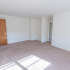 Large living room with beige carpeting and natural light at Evergreen Club apartments for rent in Broomall, PA