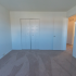 Second bedroom with closet and beige carpeting
