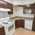 Model kitchen with wood cabinets and modern appliances at Winslow House Apartments in Blackwood, NJ.