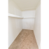 Carpeted walk-in closet with clothes bar and shelf at Winslow House Apartments in Blackwood, NJ.