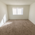 Carpeted bedroom with a large window at Winslow House Apartments in Blackwood, NJ.