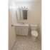 Model bathroom with tiled floors, vanity sink and toilet at Winslow House Apartments in Blackwood, NJ.