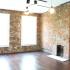 Interior living space with oversized windows, high ceilings, and brick walls at Maven @ 806 | Apartments For Rent Louisville, KY