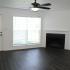 B2 - Renovated Apartment - Wood-plank style flooring, fireplace, & fan in living room at  | The Residence at Turnberry | Columbus Apartments
