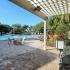 Grill Area with Pool and Sun Deck with Loungers at Bay Crossings; South Tampa Apartments