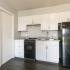 kitchen with white cabinets and black appliances at Woodgate Apartments in Springfield MO