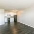 living room and kitchen with hardwood floors at Woodgate Apartments in Springfield MO